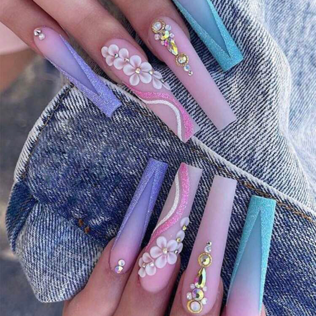 false press on nails that are pink blue and purple with flower and jewel accent designs 