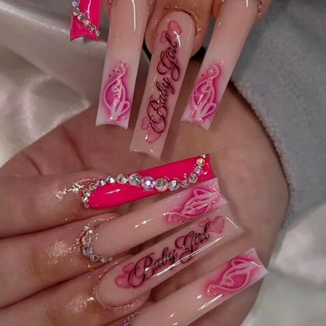 false press on nails in a long coffin shape with pink airbrush graphic designs on the accent nails