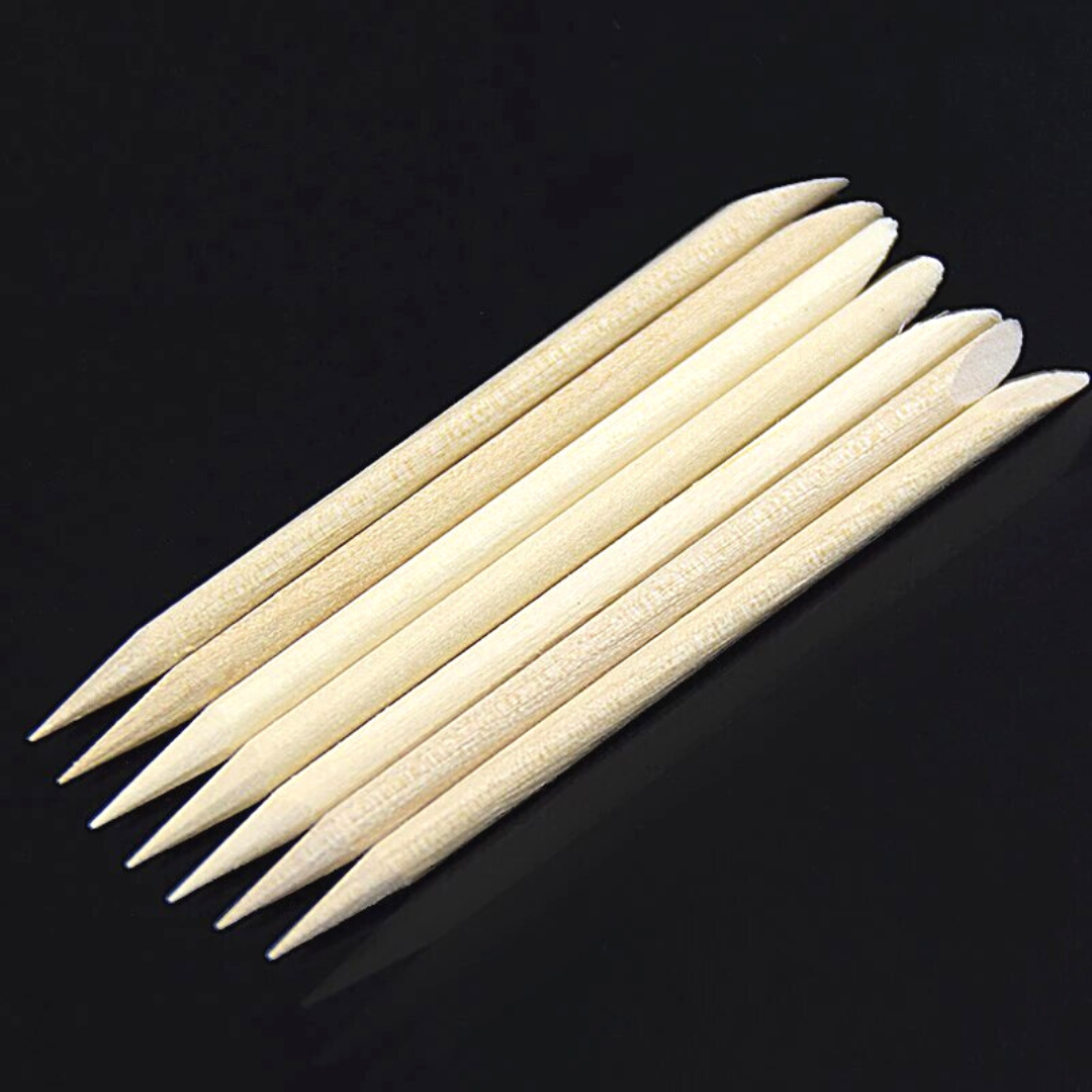 a short sharpened soft wood stick to trim your cuticles and clean under your nails